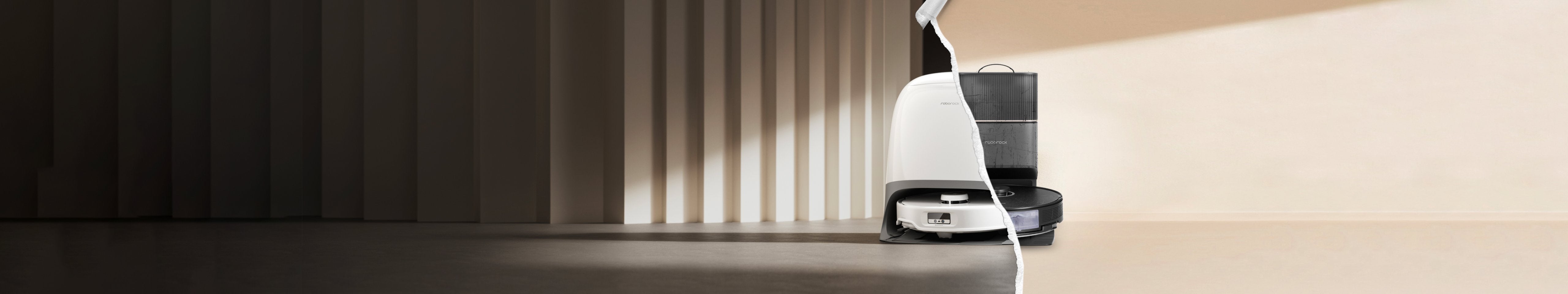 A layer showing an old black robot vacuum docked in a base station is being torn away to reveal a new white robot vacuum docked in a base station underneath