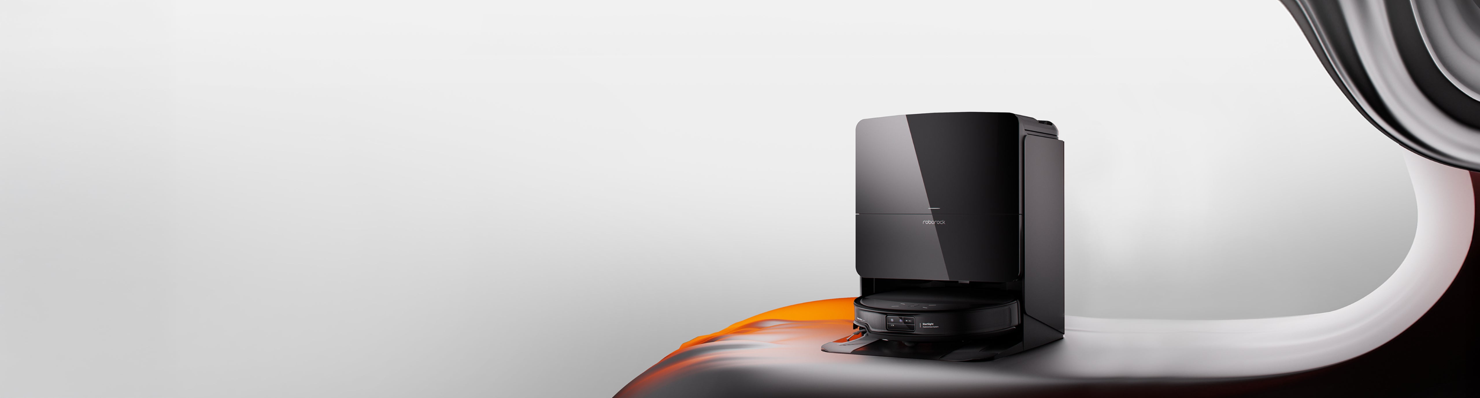 Black Roborock Saros 10R robot vacuum docked in its tall base station