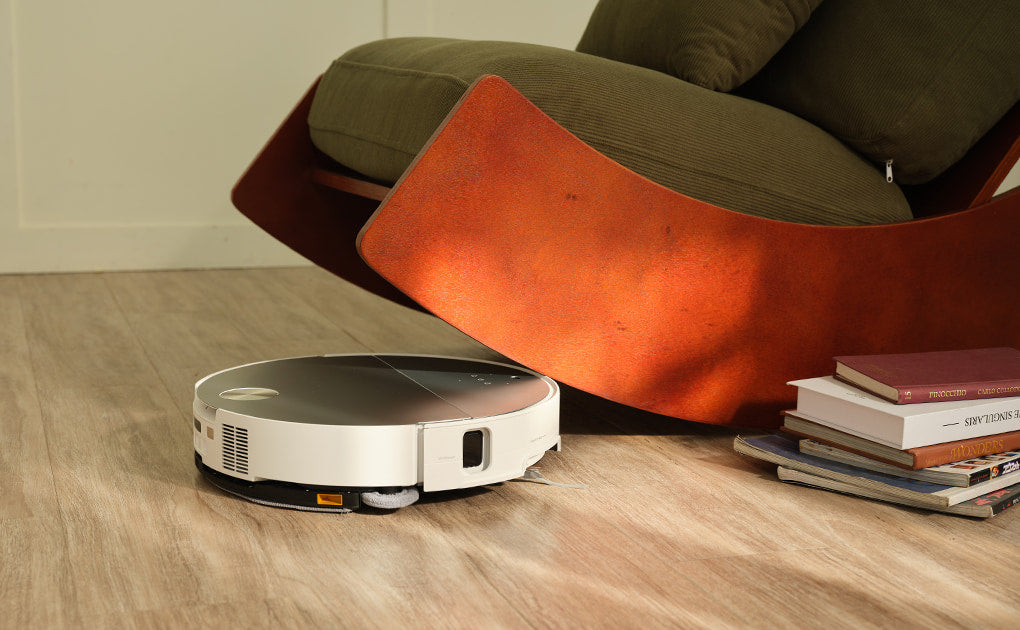 Saros 10 robot vacuum cleaning near furniture.